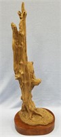 Resin figurine of bear about 26" tall on wood base