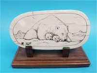 Fossilized mammoth ivory of bears on wood base by