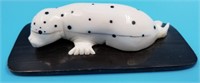 Ivory scrimshaw of spotted seal by Dennis Pungowiy