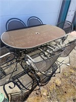 Fancy patio table with six spring loaded chairs