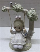 Precious moments figure of girl on swing