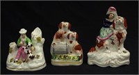 Three Victorian Staffordshire figures with dogs