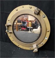 Vintage brass-framed porthole mirror