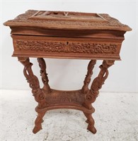 Carved Asian occasional table with opening top,