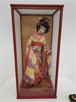 Geisha doll in a glass display case