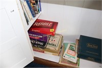 Shelf of board games, battleship,  and books