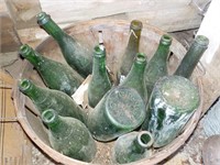 Buschel basket of antique green bottles, SHED