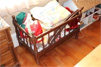 SMALL WOODEN CRIB WITH BLANKETS AND STUFFED