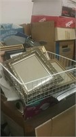 White wire basket with many picture frames