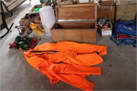 WOODEN TRUNK WITH ORANGE WARM JUMPSUIT AND JACKET