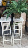 Two matching white tall plant stands with a fake