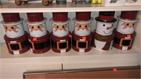 6 cnt. of Stacking Christmas Tins - 5 Santa’s and