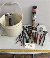 Pail of assorted pliers and punches