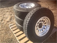 4 Unused studded truck tires and aluminum rims.