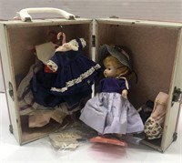 Doll and vintage doll clothes in doll trunk