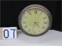 Round wall clock with Roman numeral face