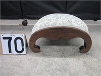 Arched upholstered foot stool