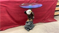 Eagle side table with glass top. Measures 24.5