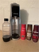 Soda stream with three bottles of syrup