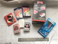 Collection of cards, shuffler, card games, pencils