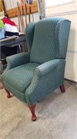 Green arm chair that recliners