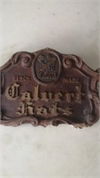 Old wood Hat advertising. 

Some damage.