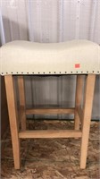 Upholstered saddle seat bar stool.