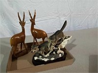 Small wolf sculpture and carved wood kudu