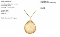 14k yellow gold pendant with carved quartz