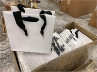 GROUP OF WHITE GIFT BAGS WITH BLACK RIBBON