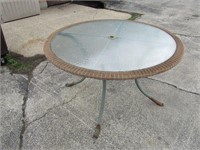 Glass Patio table wicker edge. 48.5" diameter.