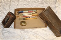 Assortment of pens and wooden boxes