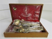 Group of gold  flatware in teak box