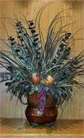 Floral arrangement with feathers & fruit