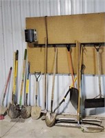 Wall of hand tools, shovels, rakes, squeegee,