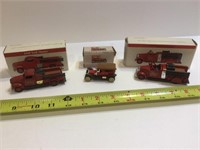 Two firetrucks and a Pierce arrow with boxes