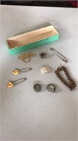 Vintage jewelry items including square nail ring
