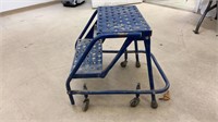 Metal step stool on wheels. Measures 18x23x19