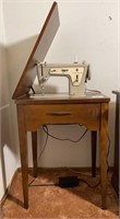 Vintage Singer sewing machine and cabinet