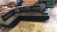 Black sectional with pullout bed and pillows new.