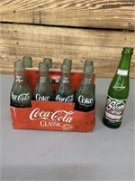 8 pack Coca-Cola bottles with carton and 1 Sun