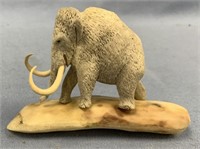 Moose antler carving of a wooly mammoth on fossili