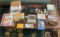 Lot of clocks, lightbulb, batteries