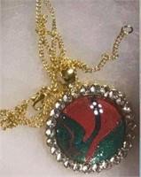 Red Green Sparkle Set in Gold colored Pendant surr