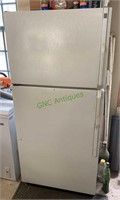 GE standard white refrigerator with freezer on