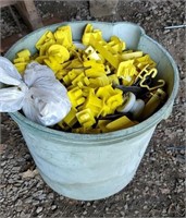 Bucket of wire insulators for electric fence