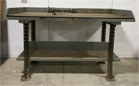 Wooden workshop table with metal legs, has built