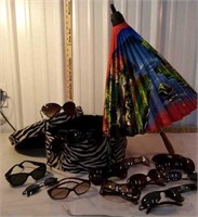 Hat box with lot of sunglasses and a parasol