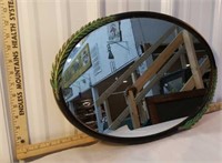 Black metal oval mirror with leaf detail and