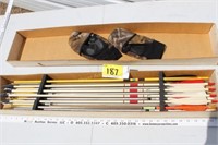 Box of arrows and pair of gloves